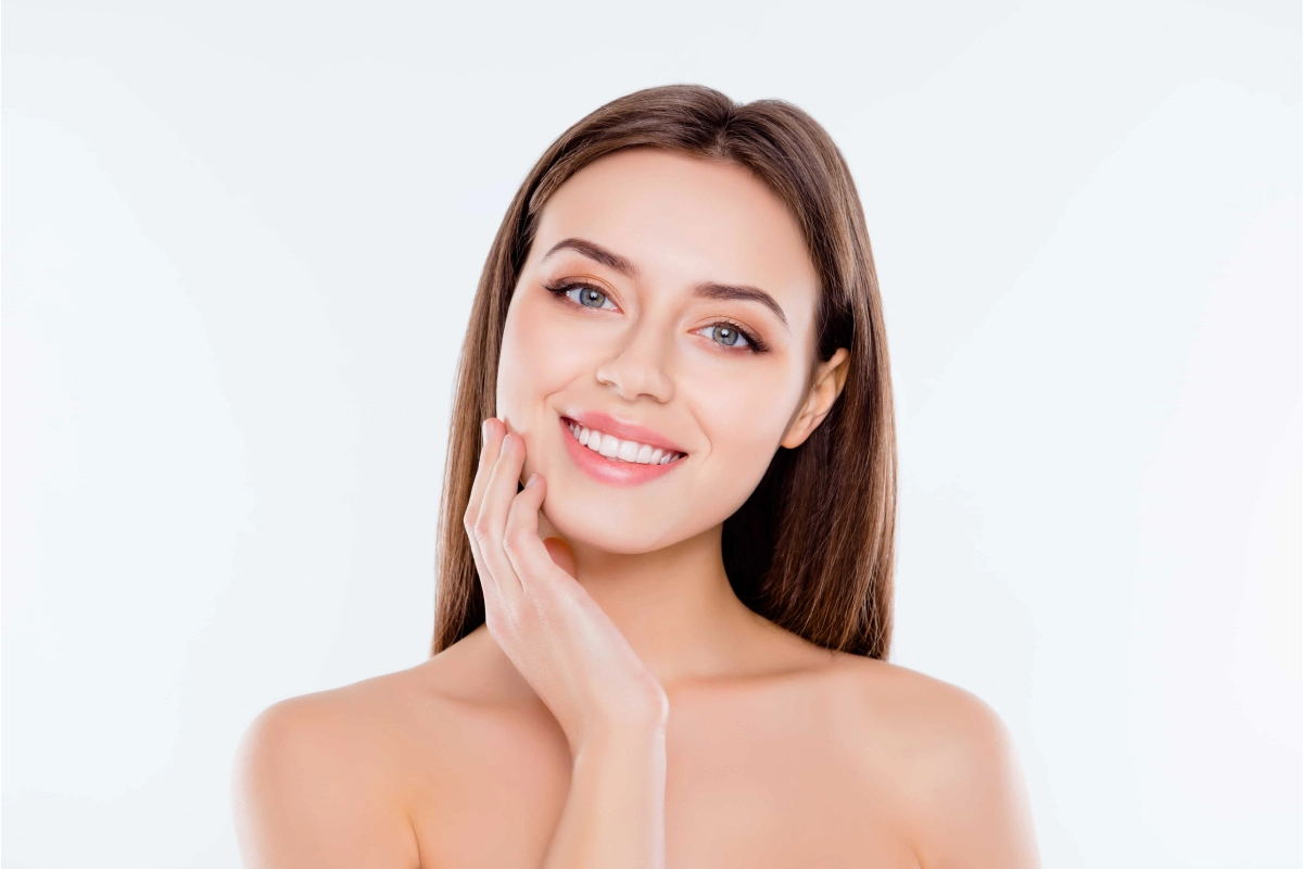Woman showing improved facial volume and jawline after Sculptra treatment